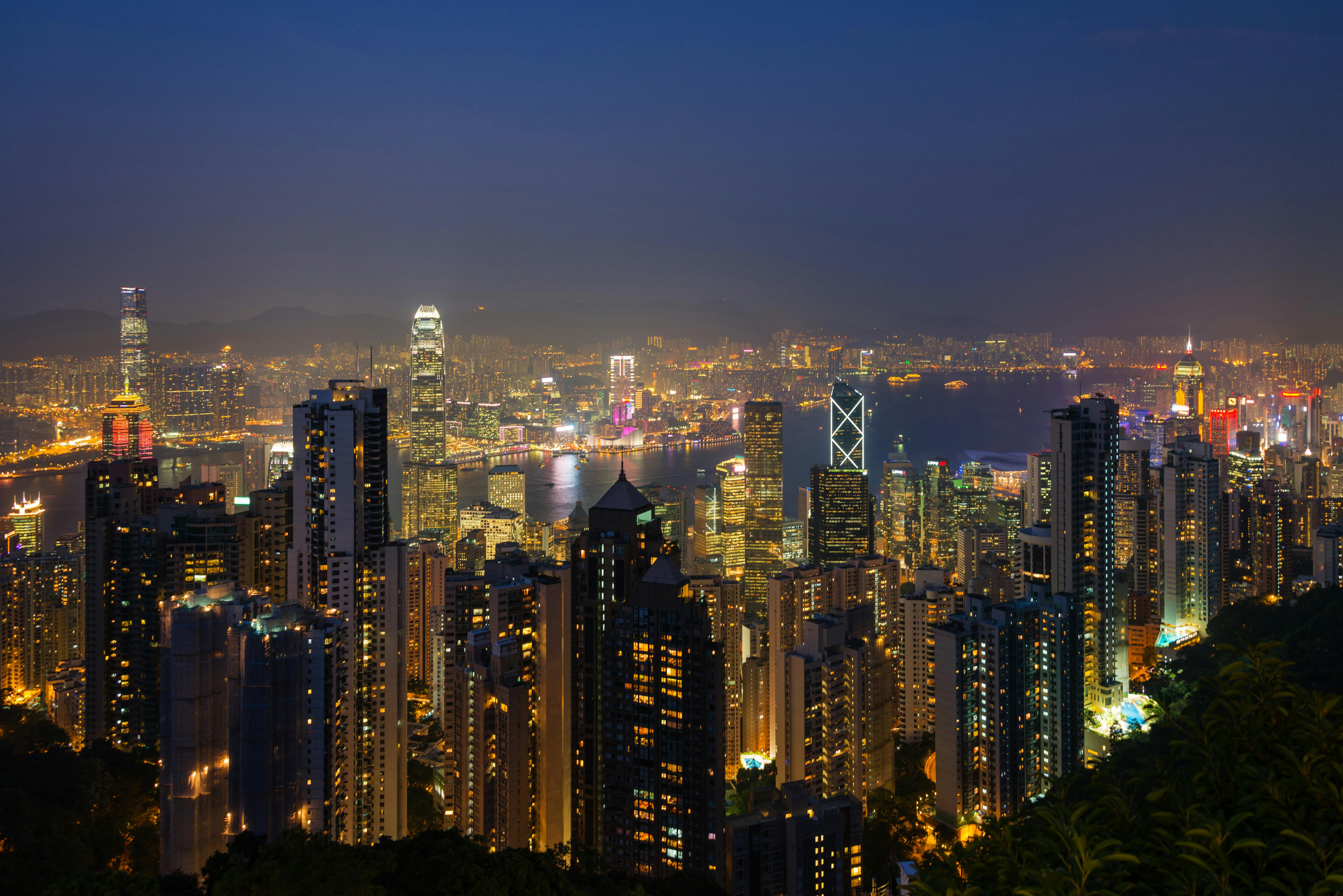 Breathtaking nighttime view of Hong Kong's vibrant skyline shining with city lights.
